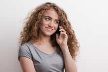 Young Beautiful Happy Woman With Smartphone In Studio, Making A Phone Call.