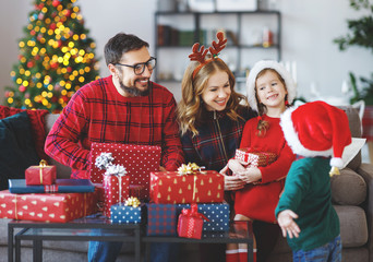 happy family   open presents on Christmas morning