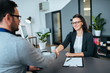 © bnenin - Business people shaking hands in modern office. Businesss agreement, partnership or job interview.