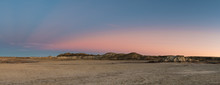 Panorama Of The Desert Landscape And Hills Of The Bisti Badlands Of New Mexico At Sunset Under A Beautiful Dramatic Sky With Blue, Pink, Peach, And Purple Hues