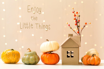 Wall Mural - enjoy the little things message with collection of autumn pumpkins with a toy house