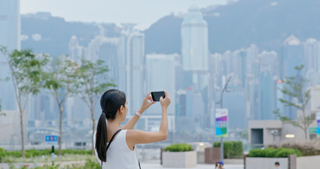 Canvas Print - Woman take photo on cellphone in Hong Kong city