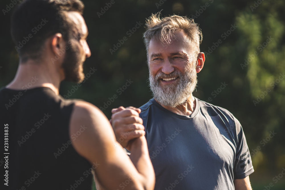 The happy father and a son handshaking outdoor - obrazy, fototapety, plakaty 