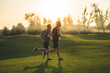 © realstock1 - The two sportsmen running on the grass in the park on the sunny background