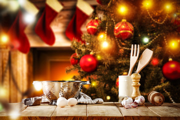 Cook hat on table and christmas tree with fireplace 