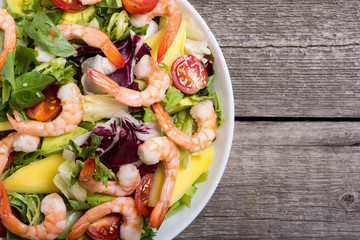 Wall Mural - Mix of salad with shrimps , avocado and cherry tomatoes . Healthy food background