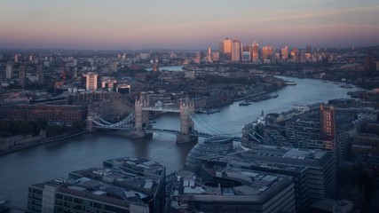 Wall Mural - time lapse London skyline with illuminated Tower bridge and Canary Wharf in sunset time, UK
