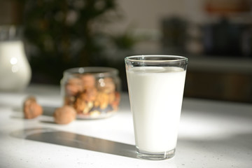 Full glass of fresh milk on light table