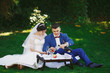 © nata_zhekova - Just married loving hipster couple in wedding dress and suit in the park. Happy bride and groom walking in the beautiful garden. Romantic Married young family.