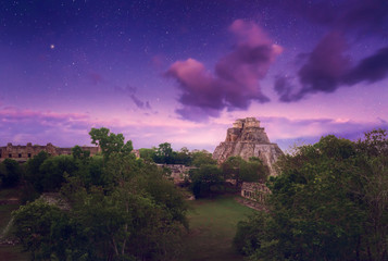 Night starry sky over the ancient Mayan city of Uxmal in Mexico.