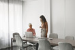 © LUMINA IMAGES - Two beautiful smiling businesswomen working together at meeting room.