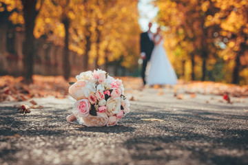 Wedding bouquet and wedding couple in orange park