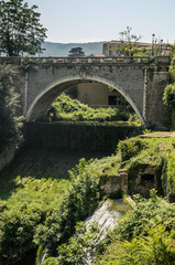 Old antique bridge over the river in Tivoli, Italy