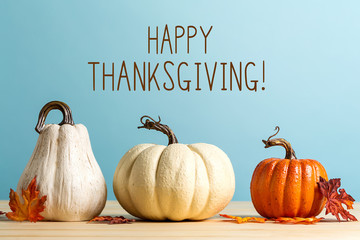 Wall Mural - thanksgiving message with pumpkins on a blue background
