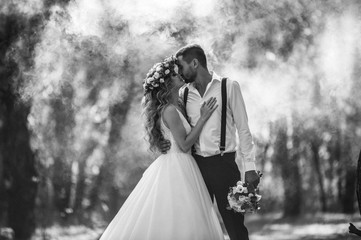 bride and groom on the background of fairy fog in the forest. Rustic wedding concept