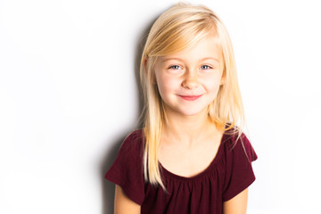 Wall Mural - A Cute girl 5 year old posing in studio