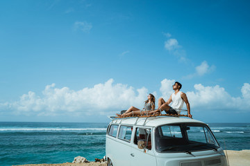 hipster holiday concept. couple with sunglasses sitting on top o