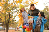 Fototapeta  - Happy family with children together in park. Autumn walk