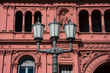 Wall Mural - Old street lamp with the Pink House (Casa Rosada) also known as Government House (Casa de Gobierno) in the background. Buenos Aires, Argentina