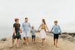 © Stocksy - A Happy Family of Six on the Beach