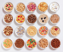Set Of Different Cereals With Milk On A White Background. 20 Bowls With Cornflakes, Kashi, Cereals And Berries. The Concept Of Breakfast Food. Flat Lay, Top View 