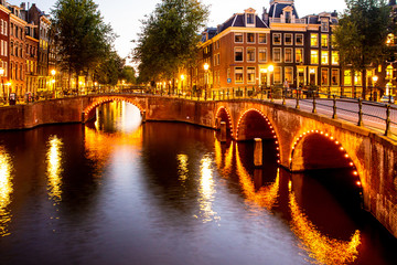 Wall Mural - Beautiful night scene from the City of Amsterdam in the Netherlands with canals and lights