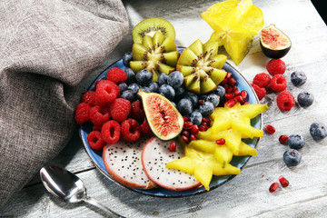 Wall Mural - fruit bowl. Bowl of healthy fresh fruit salad on rustic background