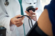© Gregory Miller - Close up of doctor taking a patient's blood pressure