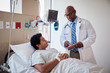 © Gregory Miller - Patient talking to doctor while lying a hospital bed