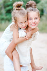 Wall Mural - Portrait of two girls in the woods girlfriends