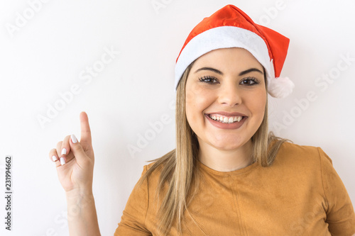 Fotografie, Tablou Brazilian woman smiling with christmas hat on white background
