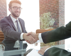 closeup. handshake between the financial Manager and the client