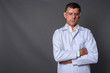 © Ranta Images - Handsome man doctor wearing protective glasses against gray back
