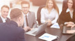 © ASDF - blurred image of business team at a Desk