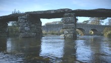 Beautiful Low Level Shot Of An Ancient Clapper Bridge On Dartmoor, England