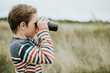 © Rawpixel.com - Young boy looking through a pair of binoculars