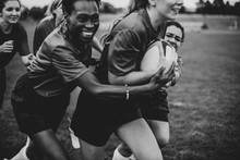 Energetic Female Rugby Players On The Field