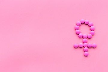 Wall Mural - Female diseases. Female gender icon symbol made of pills on pink background top view copy space