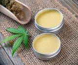 Fototapeta  - Cannabis hemp creams with marijuana leaf and nugs
