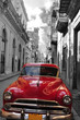 Retro car red and black-white photo of the old Havana street. Cuba. artistic photo.

