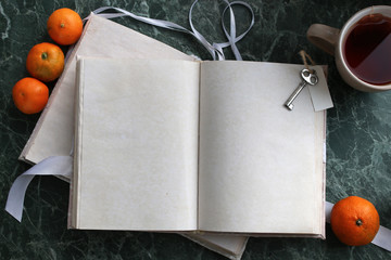 Canvas Print - pages opened vintage book on green marble countertop