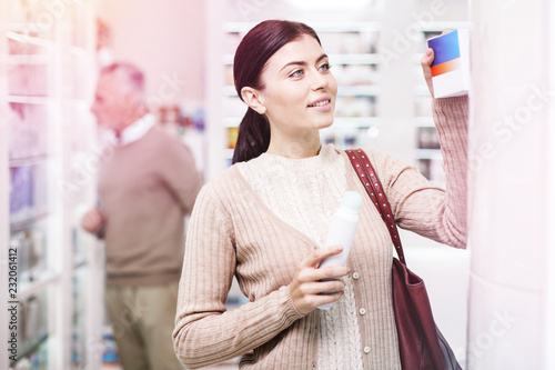 Fotografía Inquisitive buyer taking prescription from the shelf