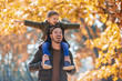 © Mediteraneo - Happy father and son having fun in autumn park