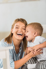 Wall Mural - happy mother having great time with cheerful son