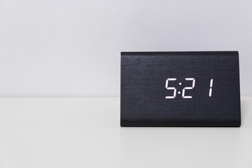 Black digital clock on a white background showing time 5:21