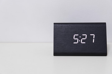 Black digital clock on a white background showing time 5:27