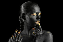 Beautiful Woman With Black And Golden Paint On Her Body Against Dark Background