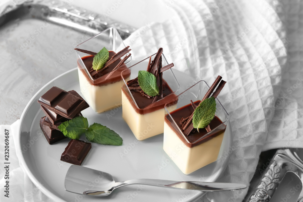 Glasses with tasty chocolate panna cotta on plate