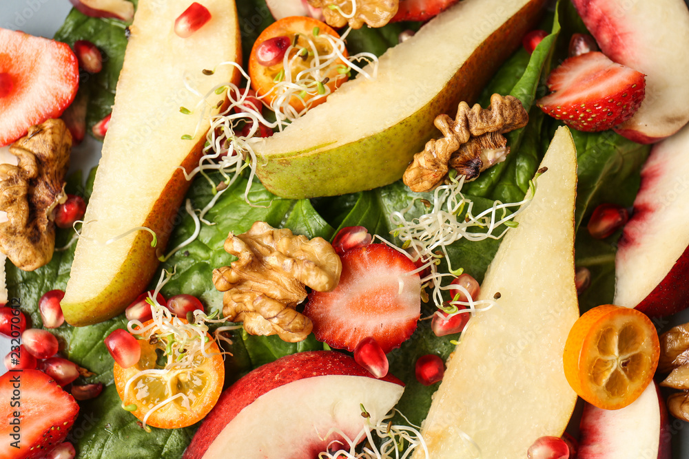 Delicious fresh salad with walnuts, closeup
