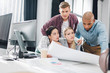 © LIGHTFIELD STUDIOS - focused young multiracial colleagues working with business charts in office